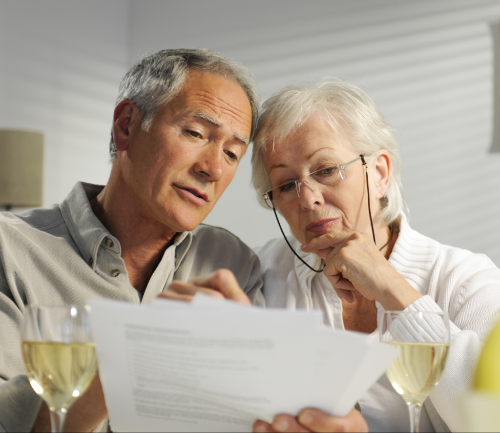 elderly couple looking at mail