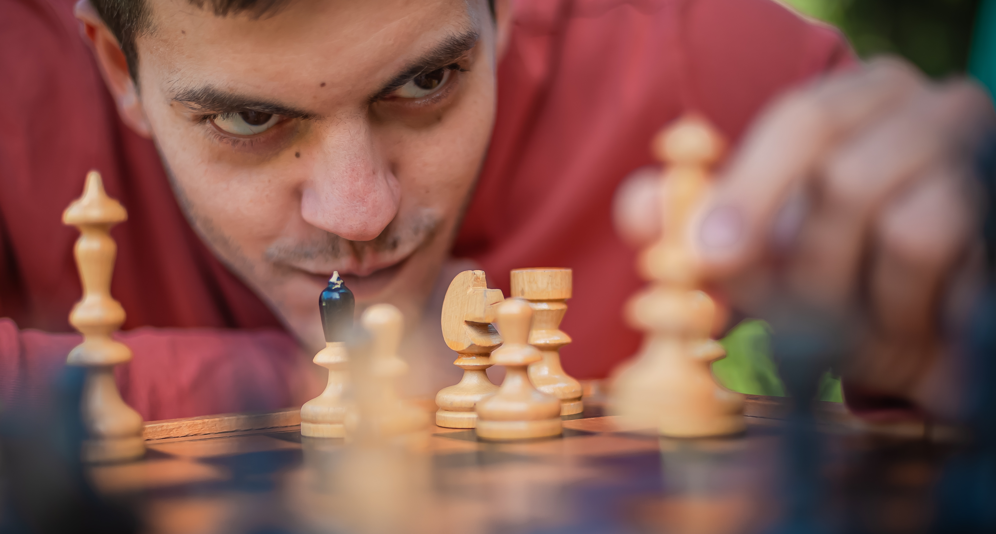 Man playing chess and moving chess piece