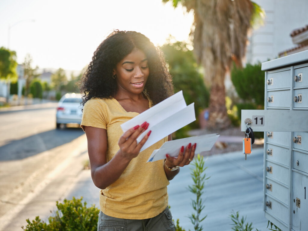 Woman grabbing mail from mailbox