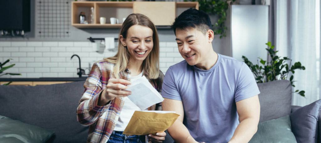 Smiling people looking at letter