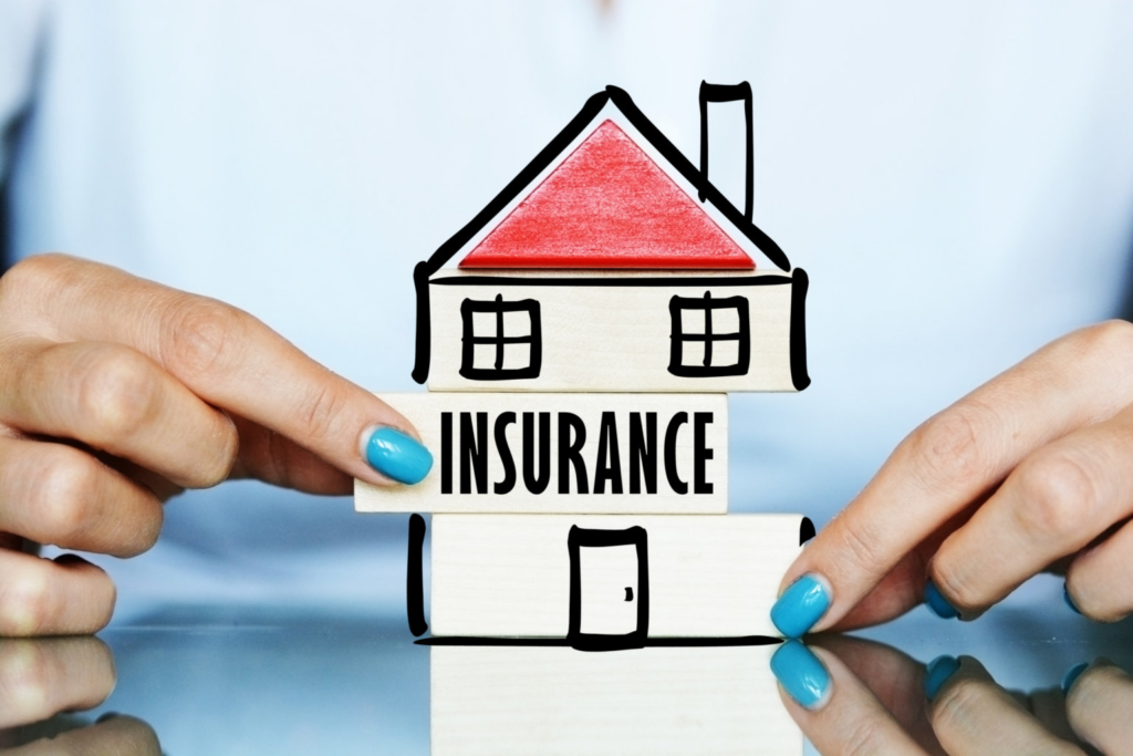 Drawn cartoon house with the word insurance on it
