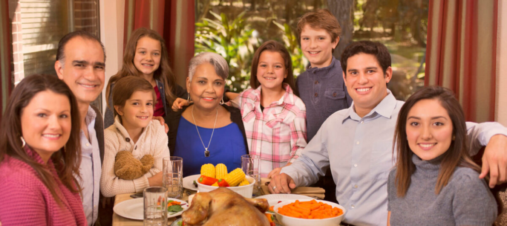 Family at table with thanksgiving dinner