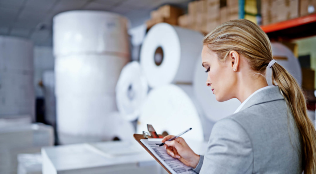 Woman taking inventory in warehouse