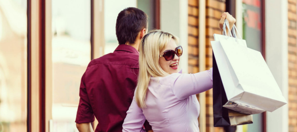 woman holding shopping bag while smiling