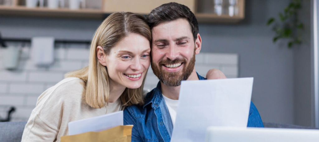 Couple smiling at a letter