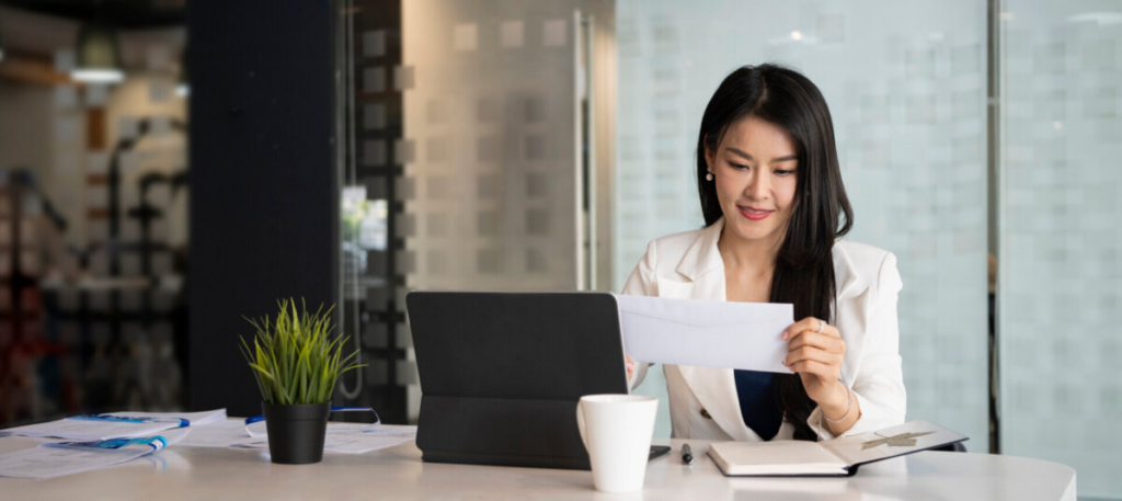 woman examining mail at her work desk