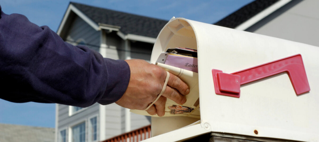 Person grabbing mail from mailbox