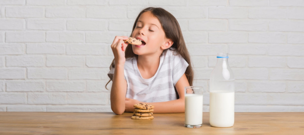 Young girl eating cookies