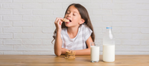 Young girl eating cookies